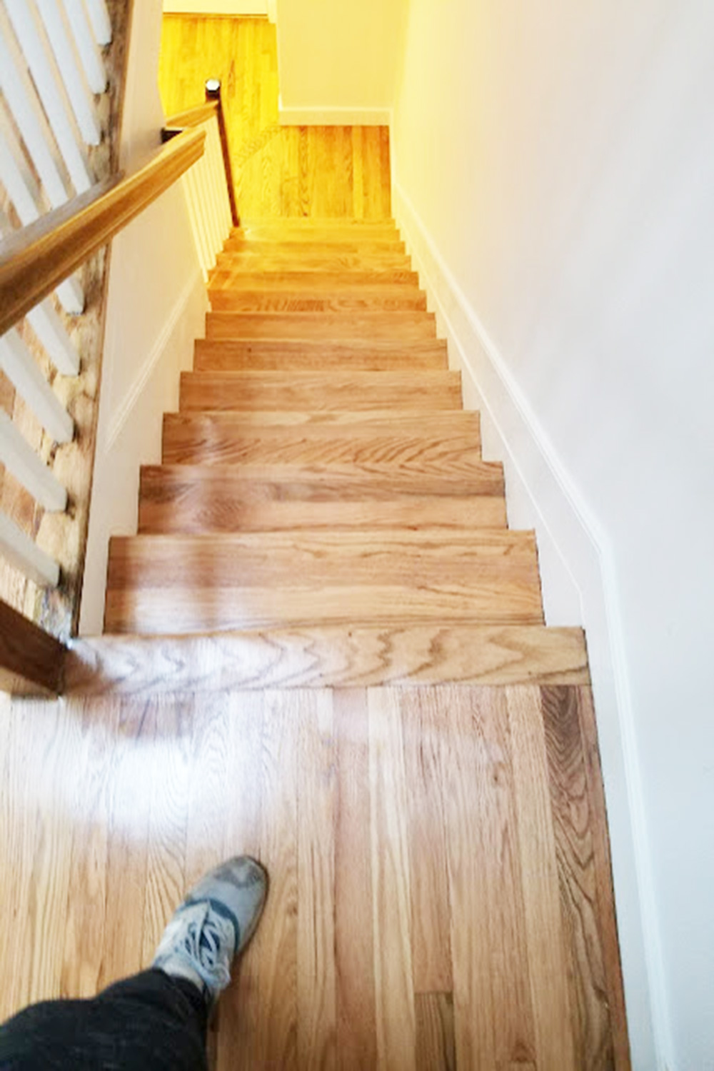 Wood stairs and rails refinished to match the floor